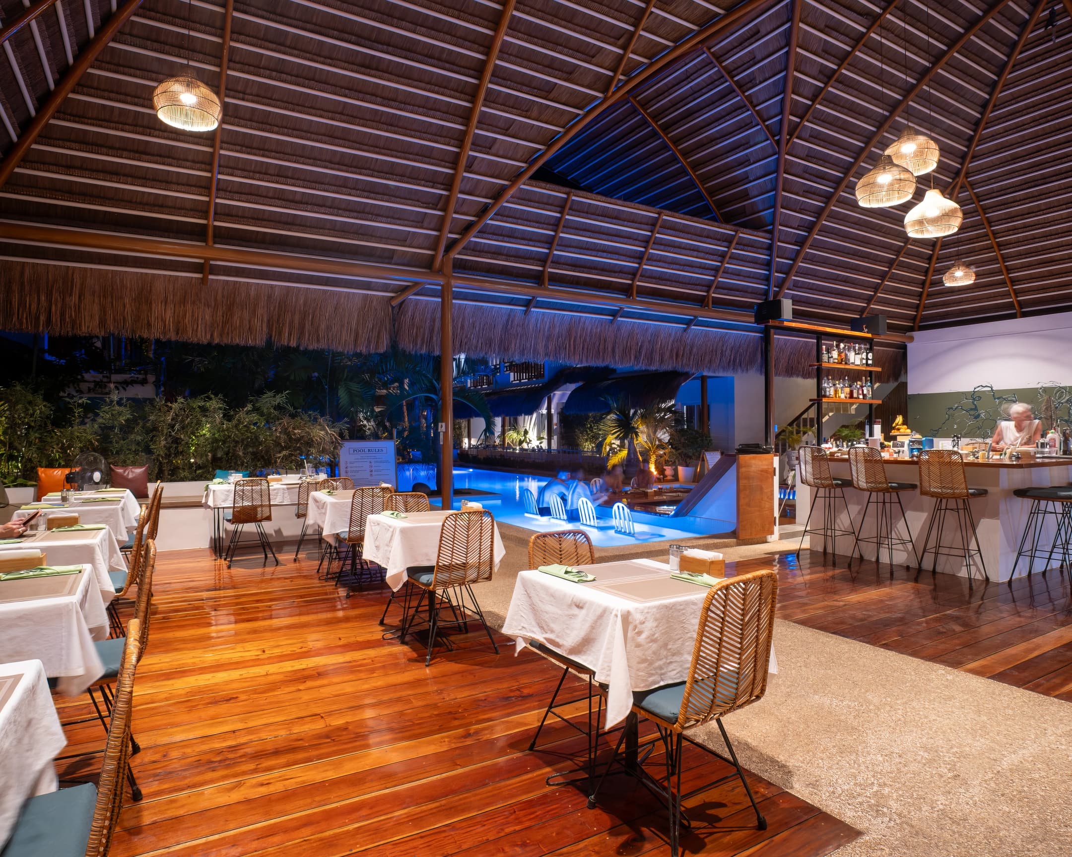 Dining tables in the open-air restaurant at Bathala Resort