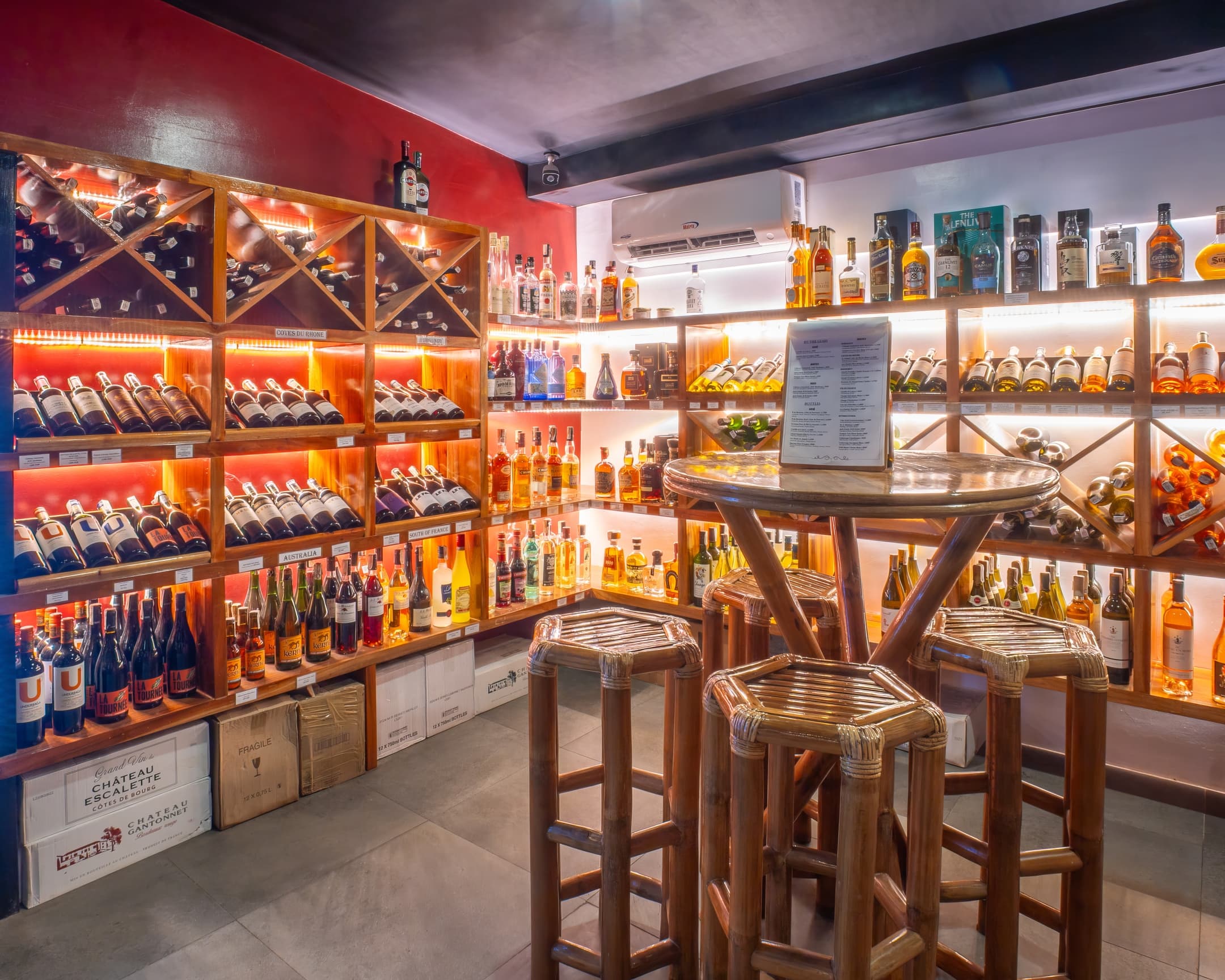 Wine cellar shelves and bar seating at Bathala Resort