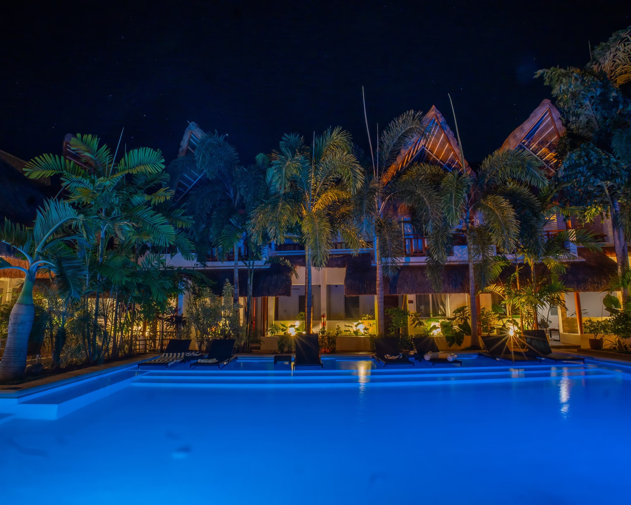 Night pool and guest rooms at Bathala Resort
