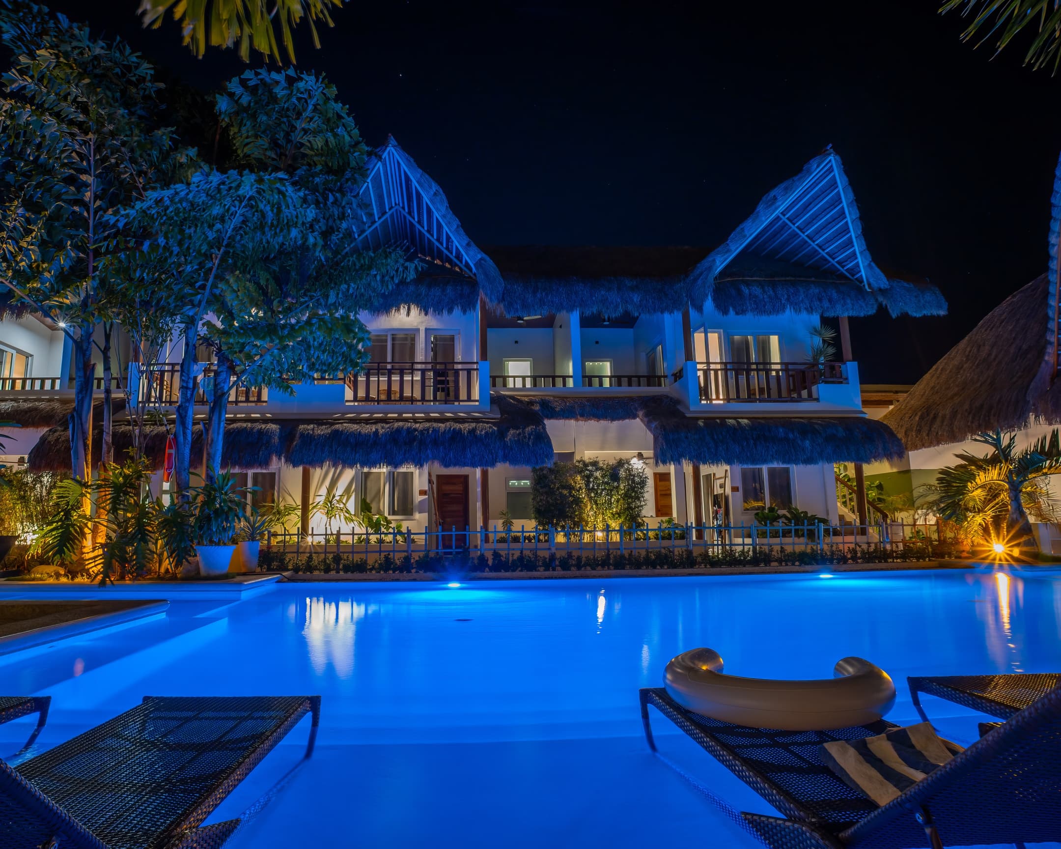 Night pool framed by Bathala Resort guest room balconies