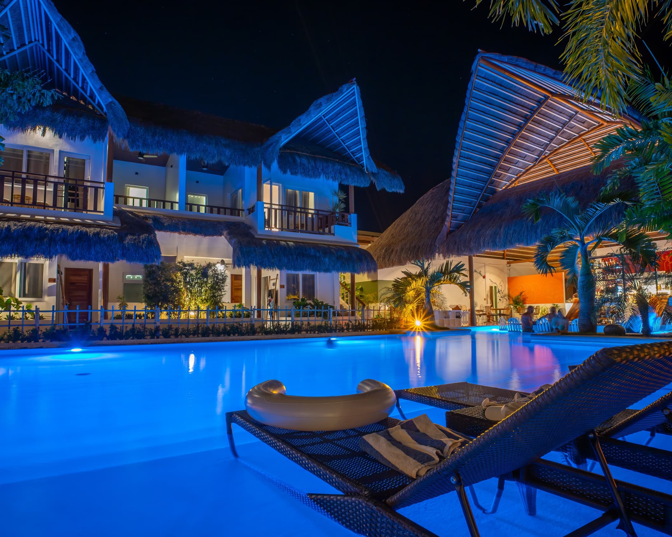 Night pool with loungers and illuminated villas at Bathala Resort