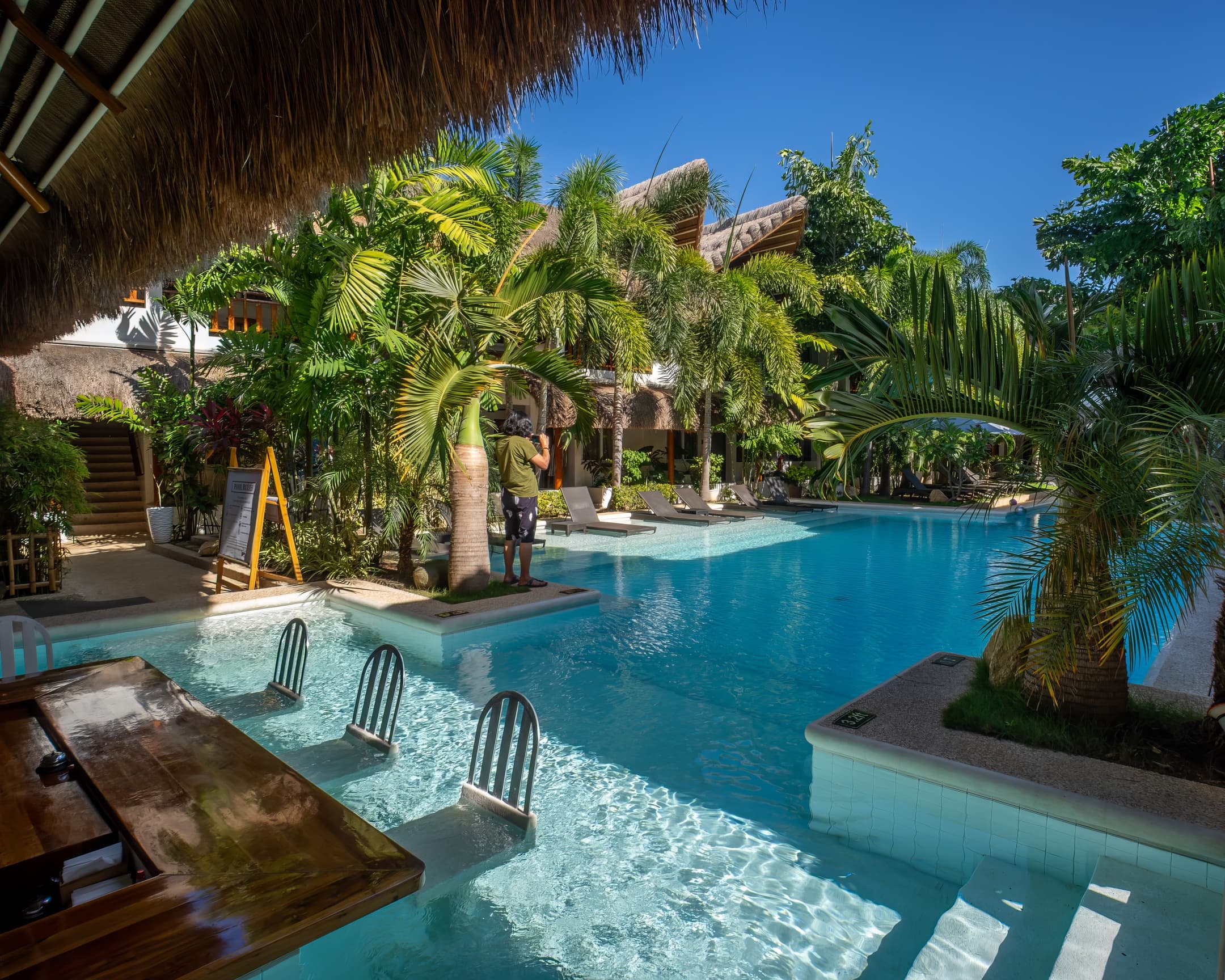 Pool and tropical courtyard viewed from the swim-up bar at Bathala Resort