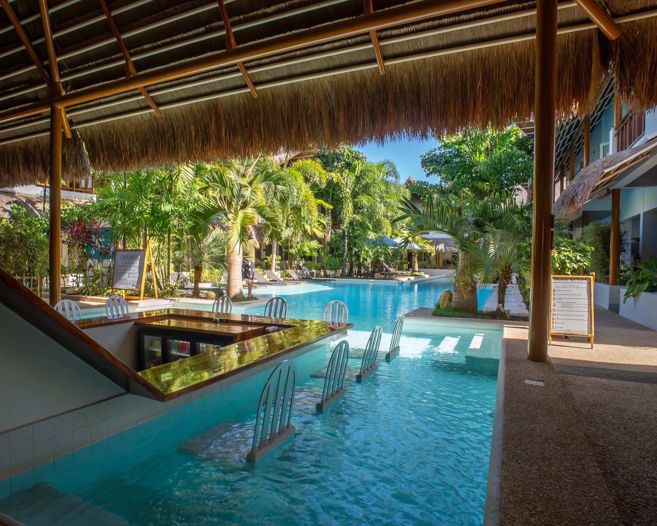 Pool ledge and resort gardens viewed from the bar at Bathala Resort
