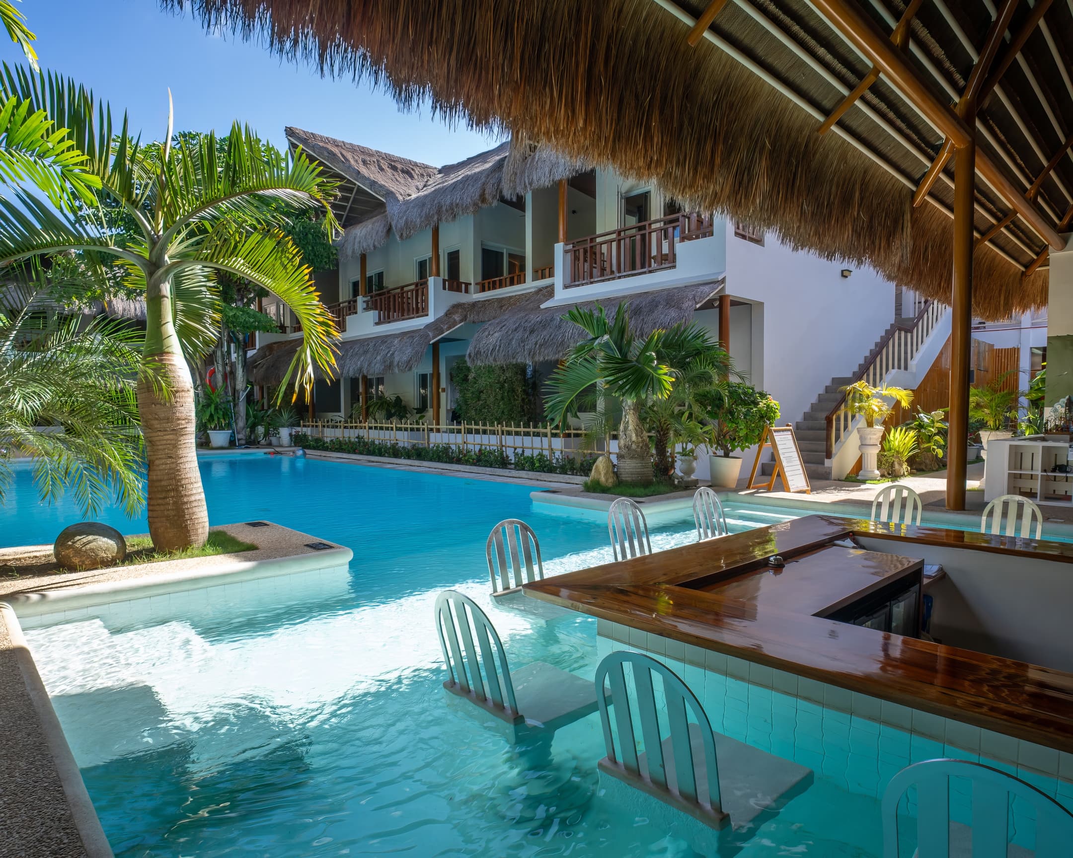Swim-up pool bar and tropical courtyard at Bathala Resort