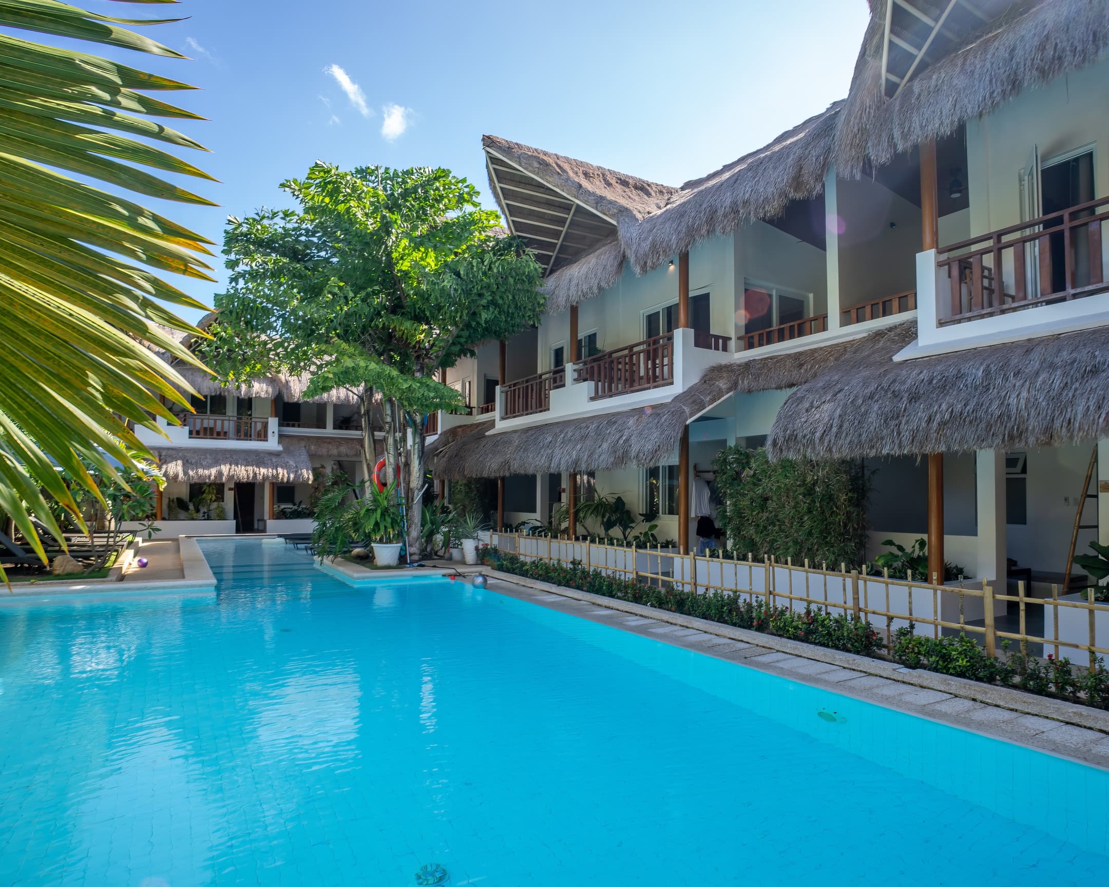 Long pool view beside guest balconies at Bathala Resort