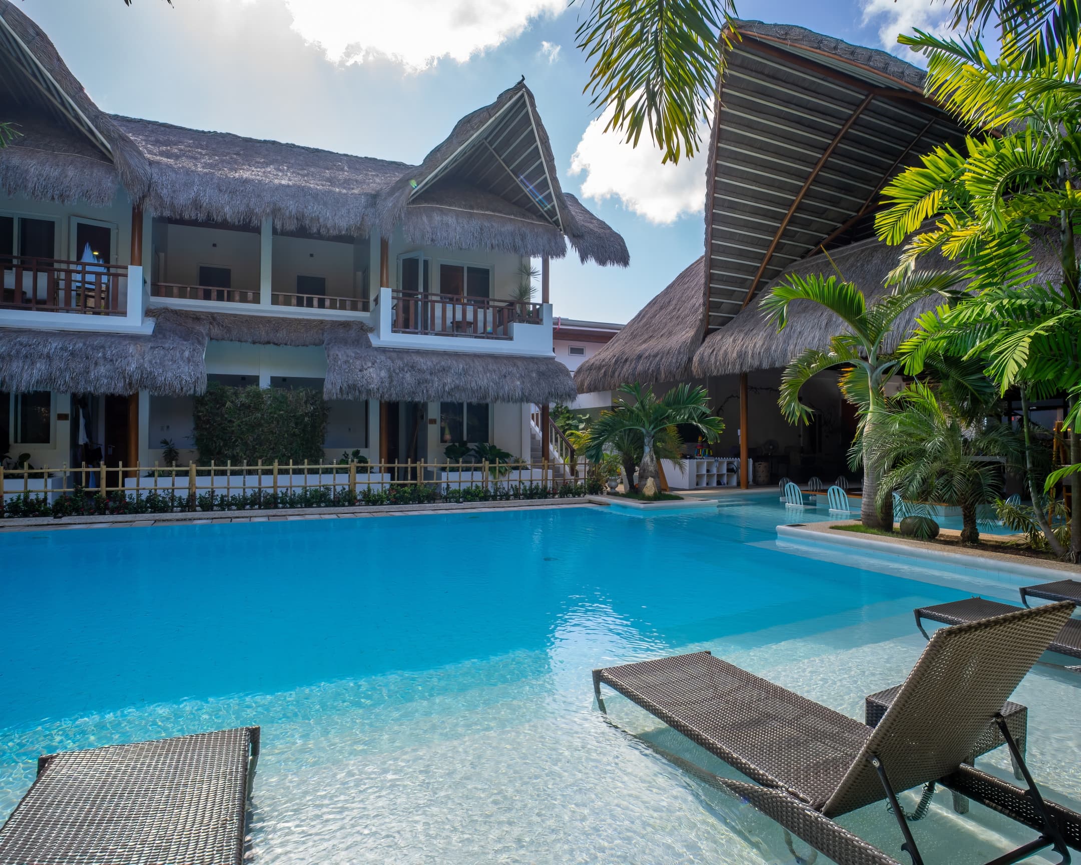 Poolside loungers facing guest balconies at Bathala Resort