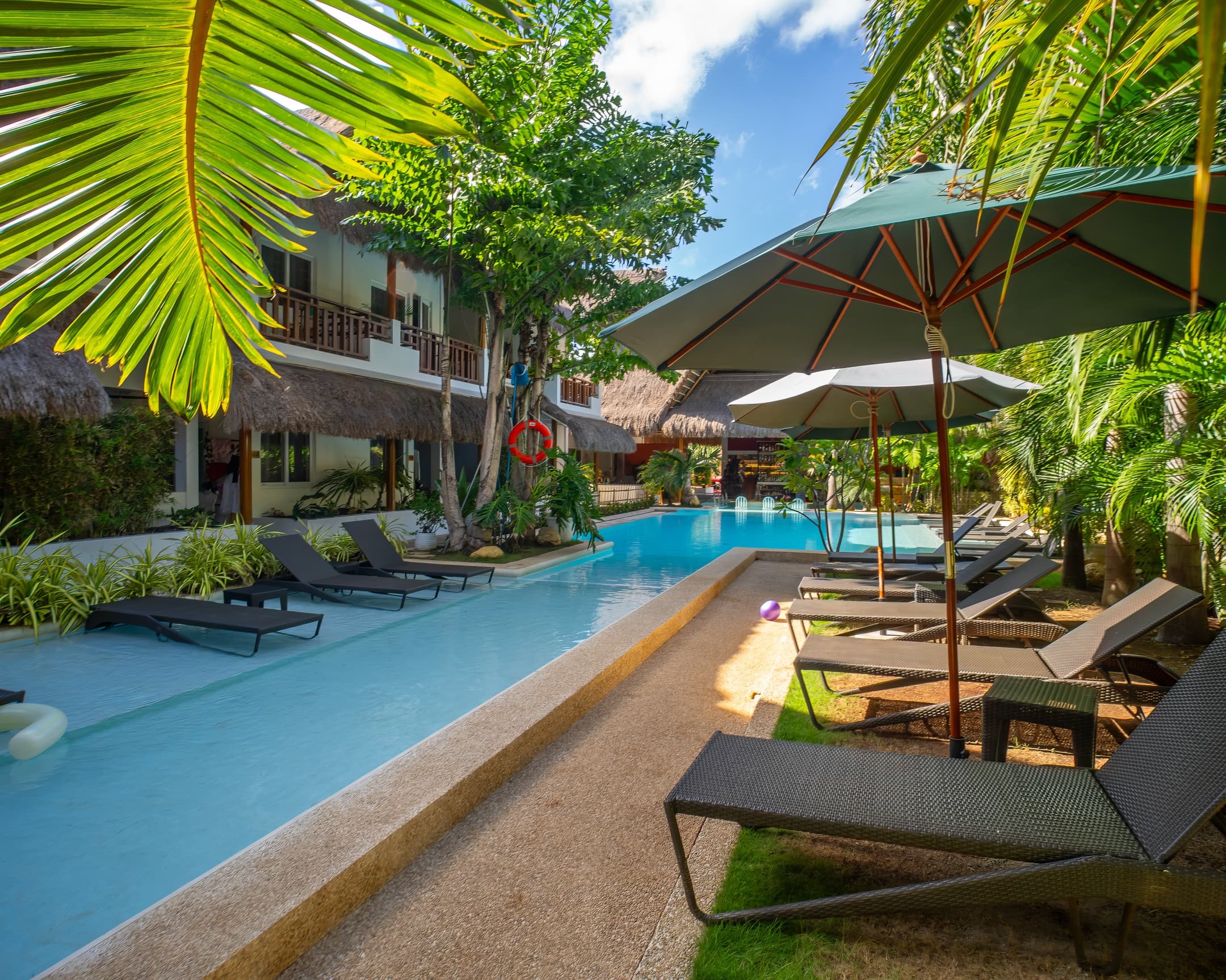 Poolside umbrellas and loungers at Bathala Resort