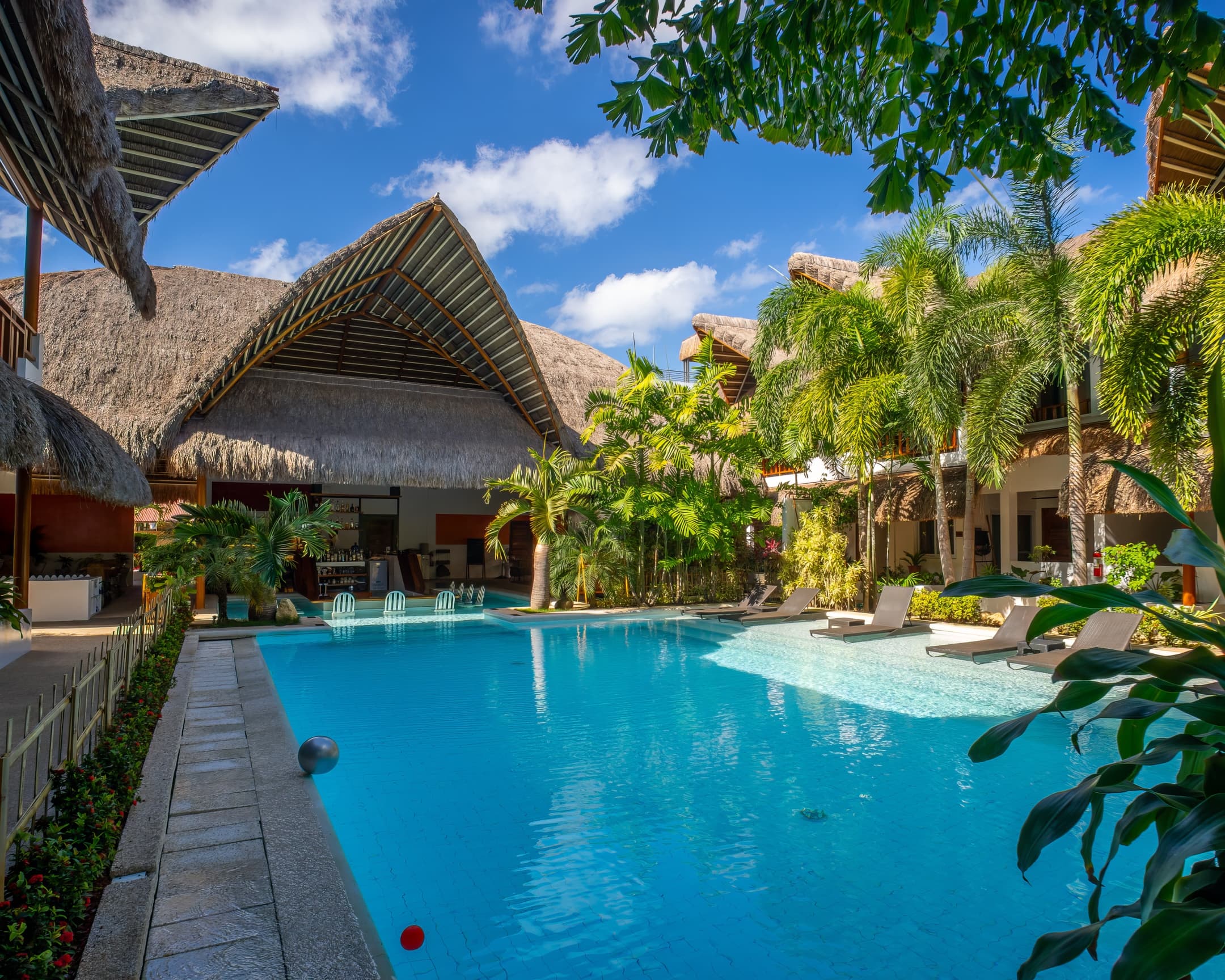 Daytime pool facing the restaurant pavilion at Bathala Resort