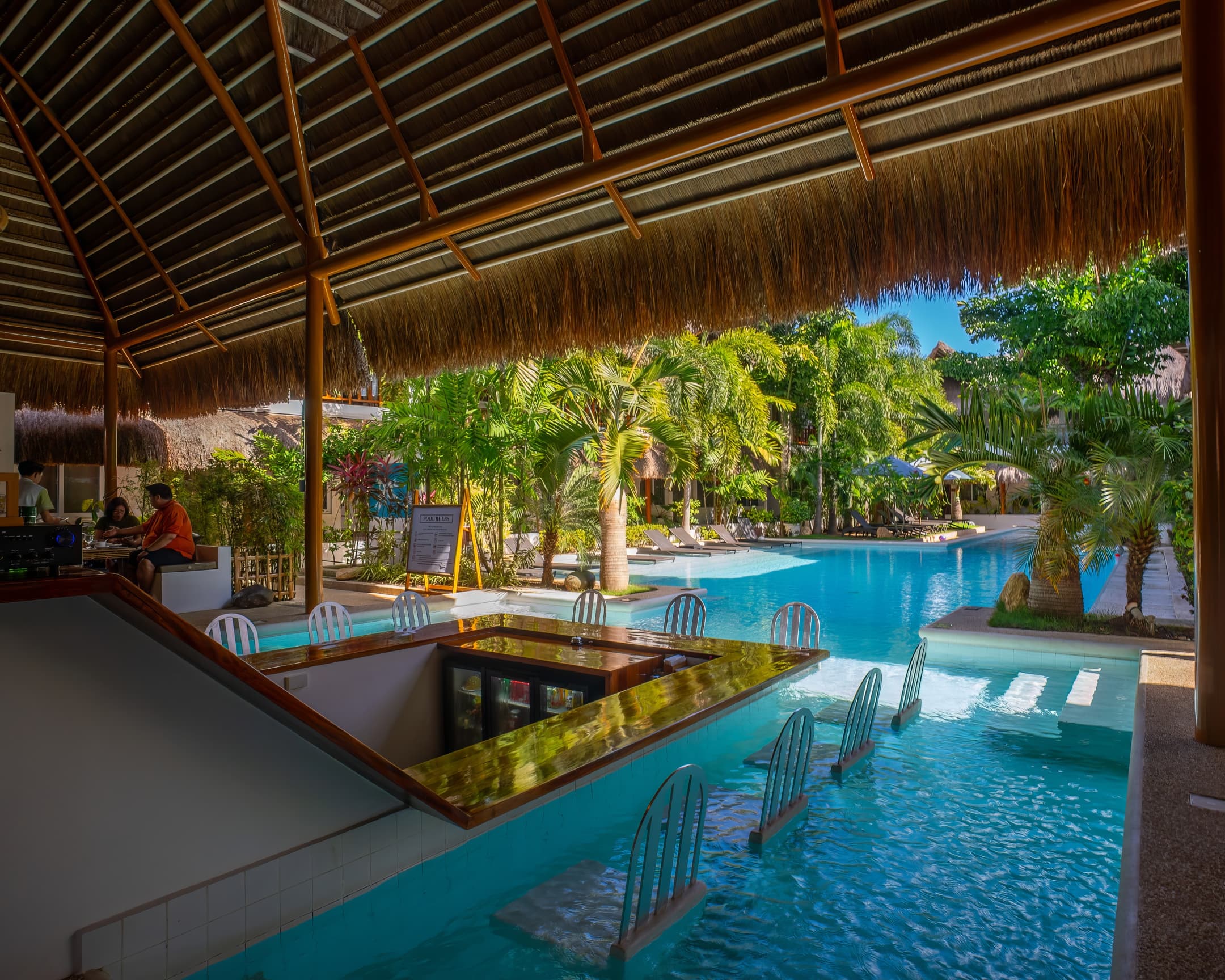 Covered swim-up bar and pool seating at Bathala Resort